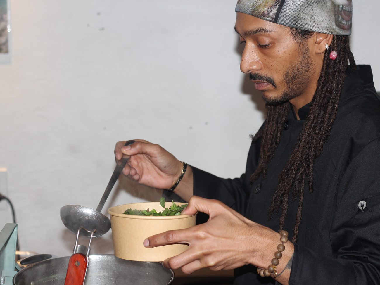 Ladling broth into a bowl at the Pho Pop-Up