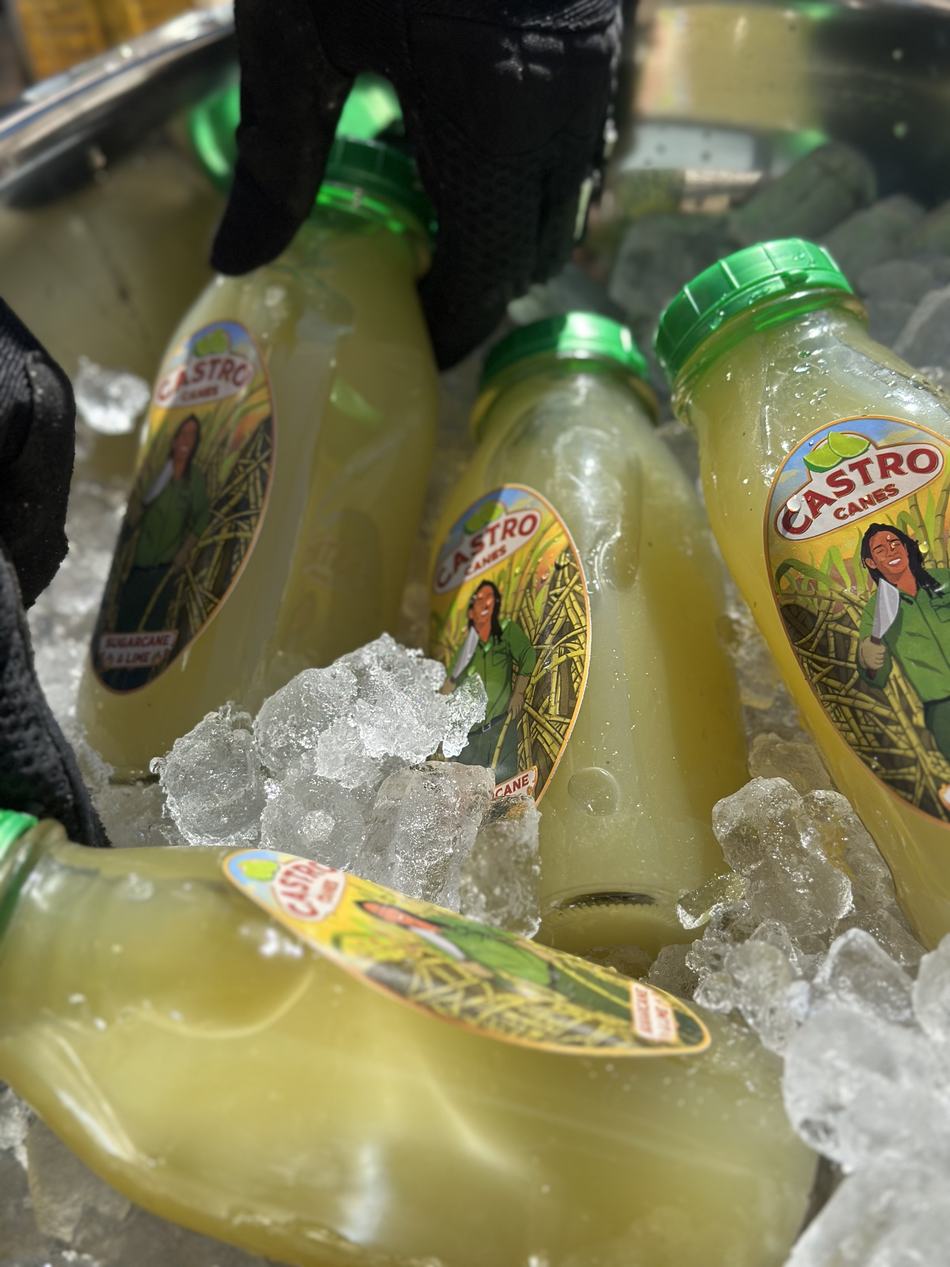 Bottles of sugarcane and lime juice resting on ice