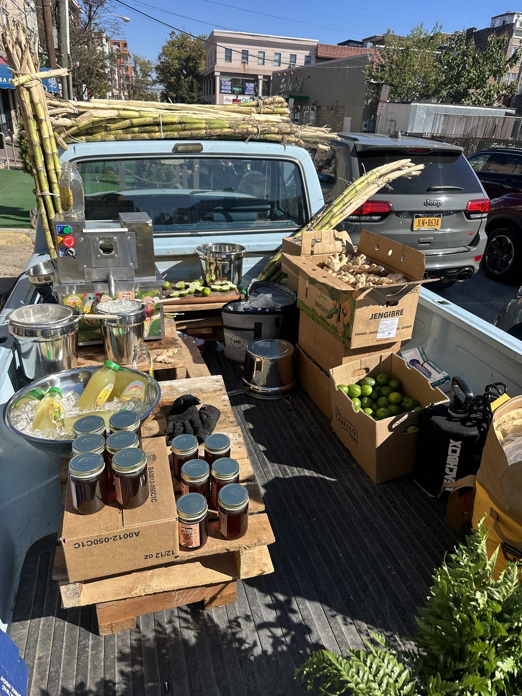 The press, bottles and produce set up across the truck bed
