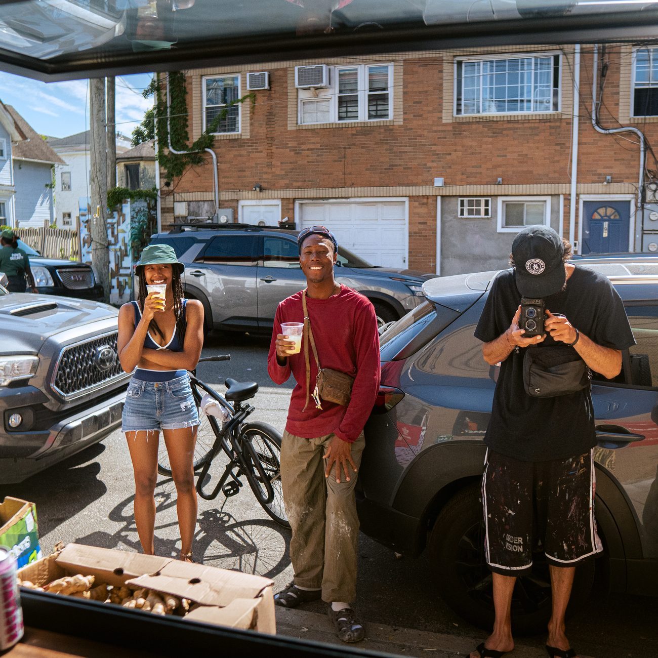 Neighbors gathered on the street with cups of fresh juice