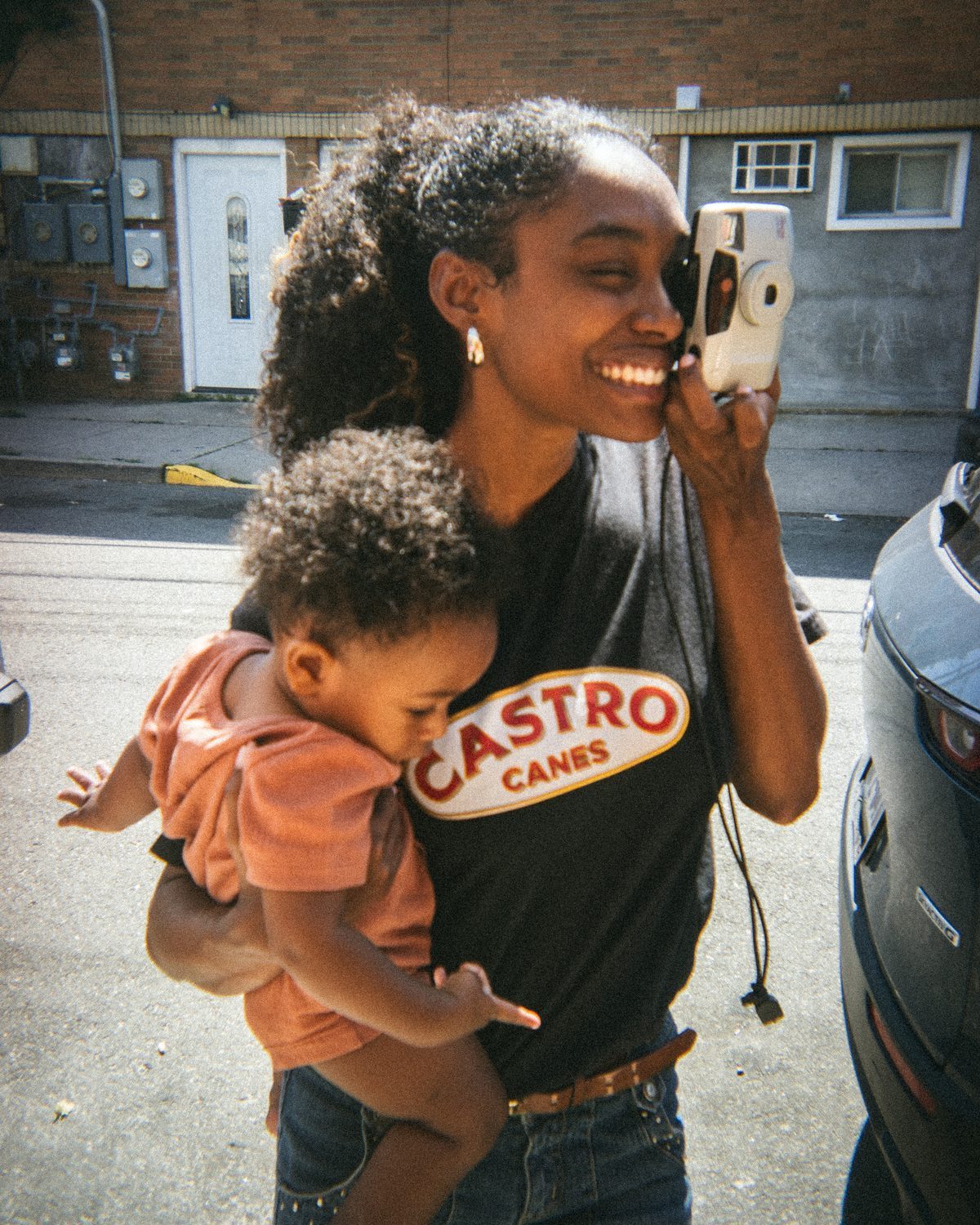 A mother laughing with her baby outside the shop