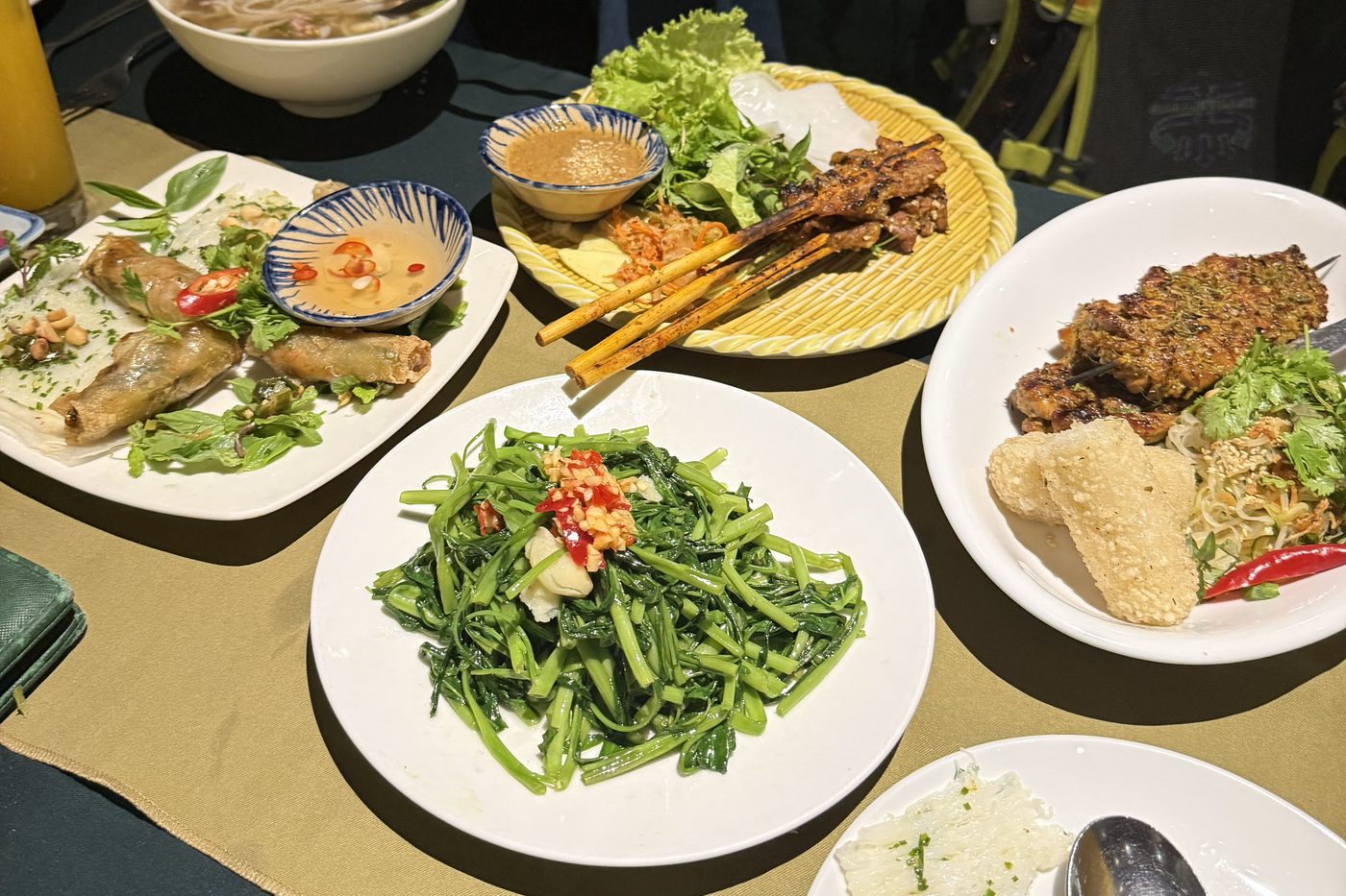 A shared table of Vietnamese dishes at the end of a lesson