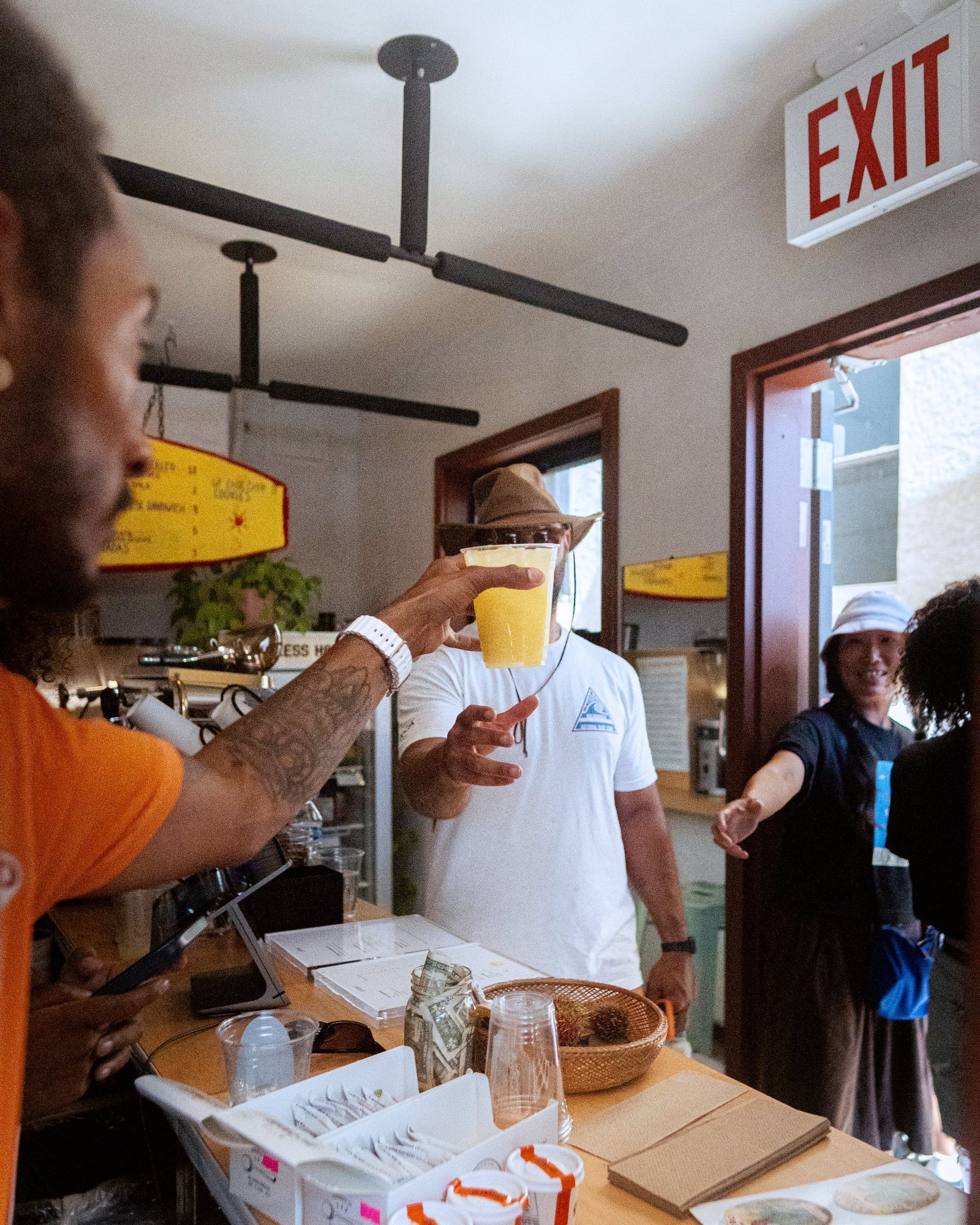 A cold cup of fresh-pressed sugarcane juice passed across the counter at the Phase Surf pop-up